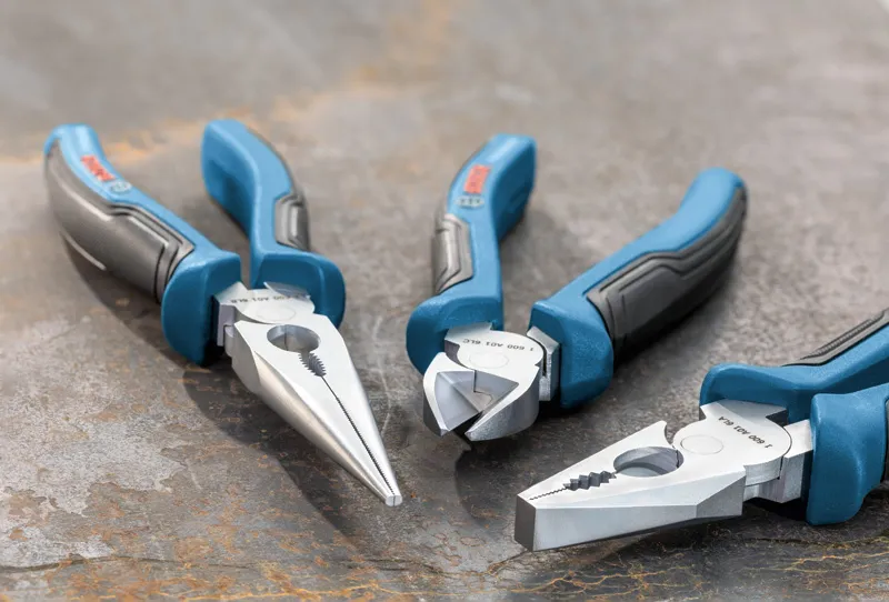 Three-piece plier set with blue and black handles arranged on a metal surface.