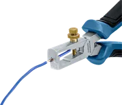 Wire stripper tool removing insulation from a blue electrical wire.