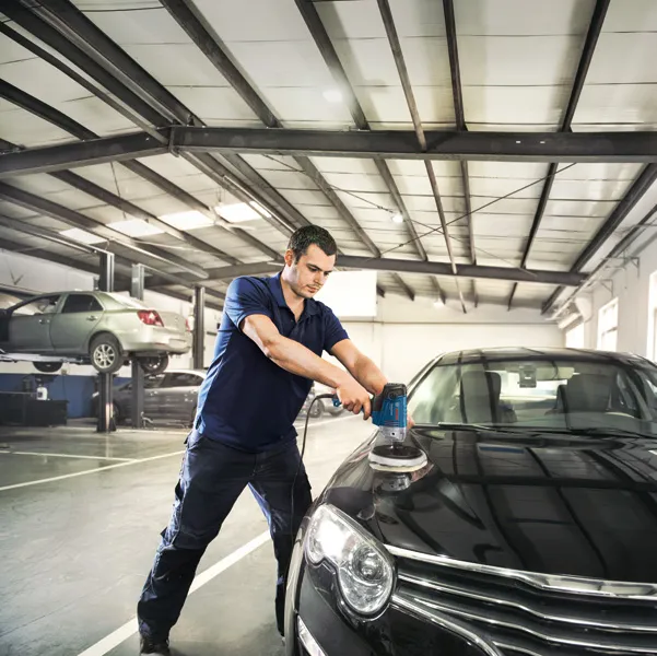 Man polishing black car.