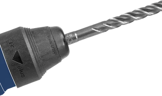 Rotary hammer drill with a spiral bit fitted in the chuck.