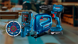 Conjunto de herramientas Bosch Professional en un taller, color azul y negro, incluyendo taladro y sierra.