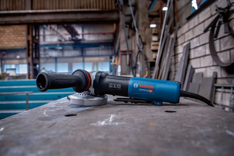 Haakse slijper op een metaalwerktafel in een industriële werkplaats.