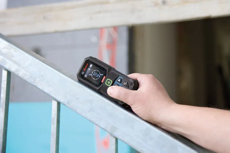Iemand gebruikt een lasermeter om de hoek van een metalen leuning te controleren.
