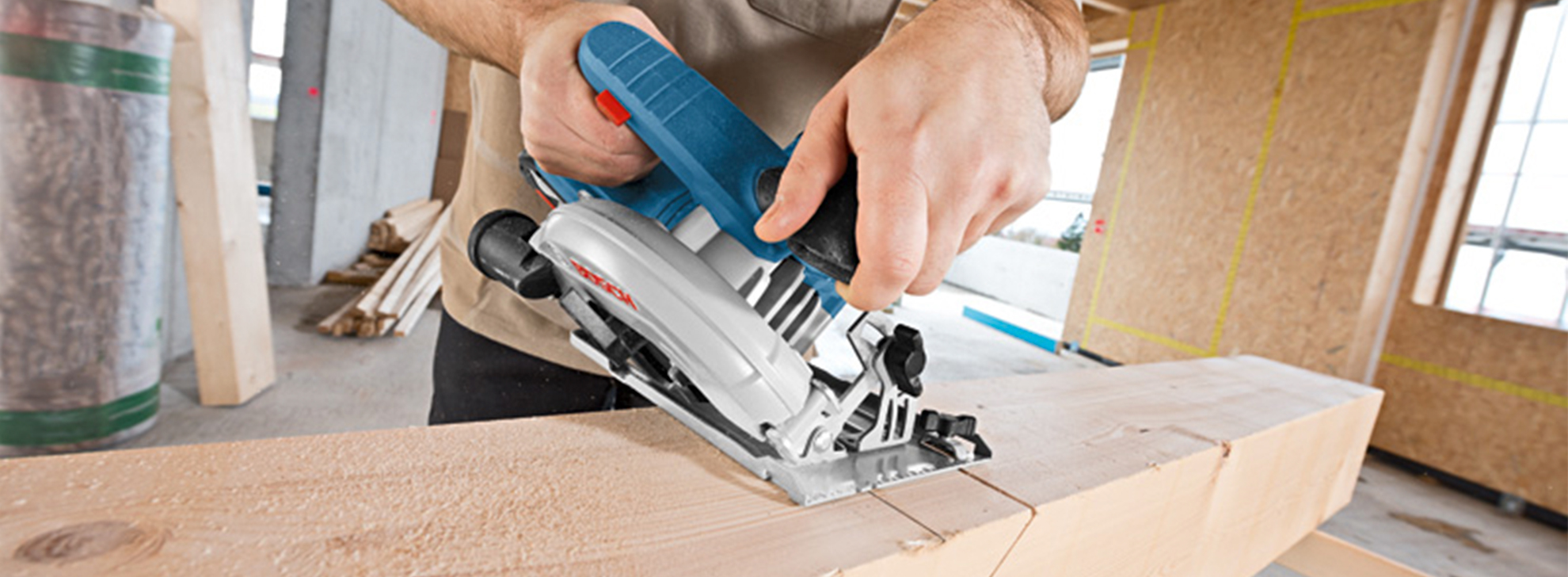 Uma pessoa usa uma serra circular Bosch Professional em uma tábua de madeira.