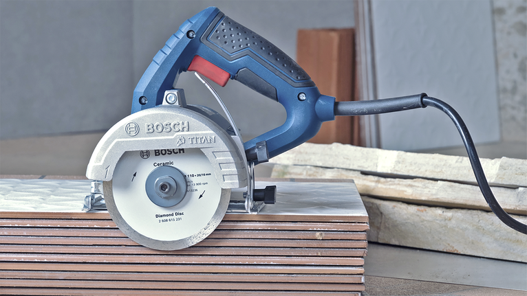 Serra circular colocada sobre ladrilhos cerâmicos empilhados, pronta para tarefas de corte.