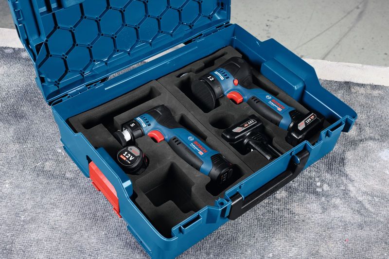 Estuche de transporte azul con pulidora y dos herramientas eléctricas inalámbricas de 12 V aseguradas en espuma.