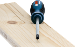 Screwdriver with a specialized tip resting on a light wooden plank.