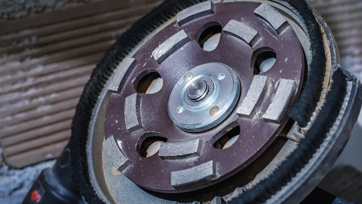 Diamond grinding wheel ready for surface preparation on a construction site.
