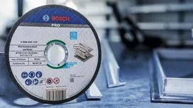 Disque à tronçonner pour métal placé sur un établi dans un environnement industriel.