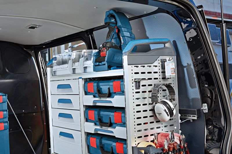 Organized tool storage system and ear protectors inside a work van.