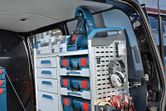Organized tool storage system and ear protectors inside a work van.