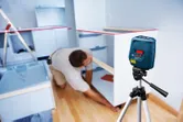 Laser level aligns cabinets.