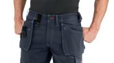 A person wearing blue work shorts with holster pockets and visible stitching.