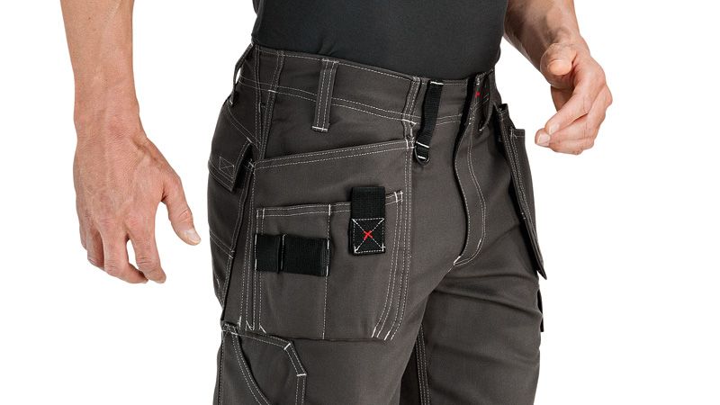 Person wearing grey shorts with holster pockets and visible stitching.