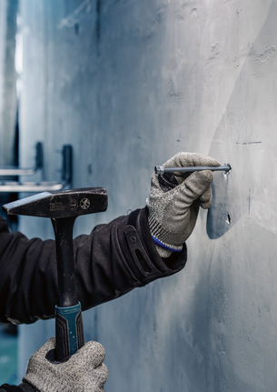 Bosch concrete chisel accessory in use.