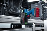Cordless industrial smart controller mounted on a metal frame in a factory setting.