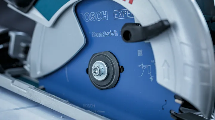 Close-up of a circular saw blade mounted in a protective metal housing.