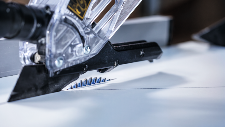 Circular saw blade cutting a straight line in a sheet of material.