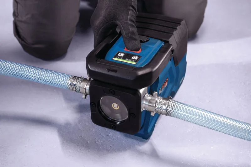 A person wearing safety equipment operates a portable water pump connected to a hose.