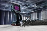Thermo camera with thermal display and three probes on a concrete block in an industrial setting.