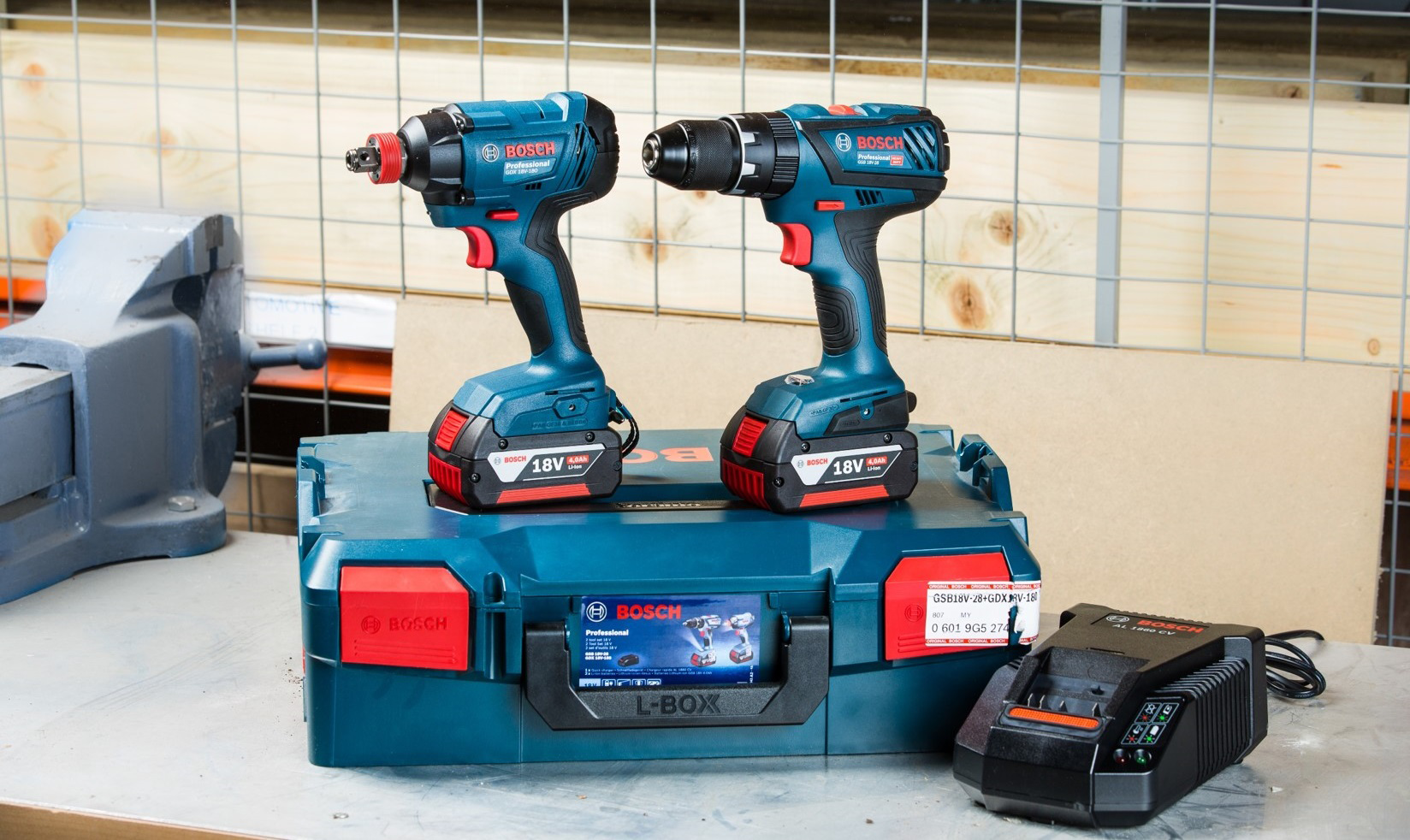 Two Bosch Professional tools on a blue case with a charger beside them.