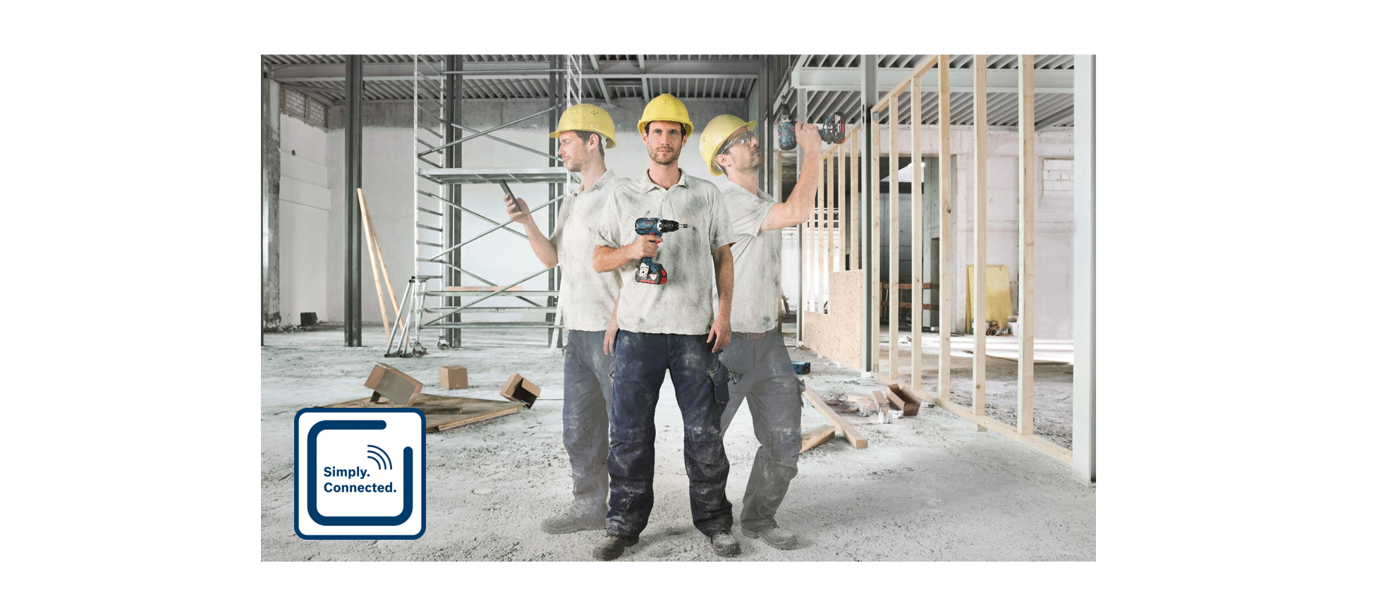 Three workers in yellow helmets use Bosch drills on a construction site with wooden frames.