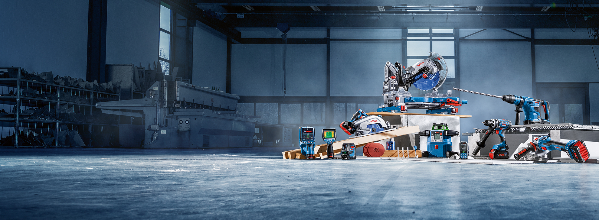 Bosch Professional tools arranged on a workbench in a bright industrial setting.