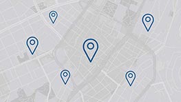 A map with five blue location pins indicating different positions in a city layout.