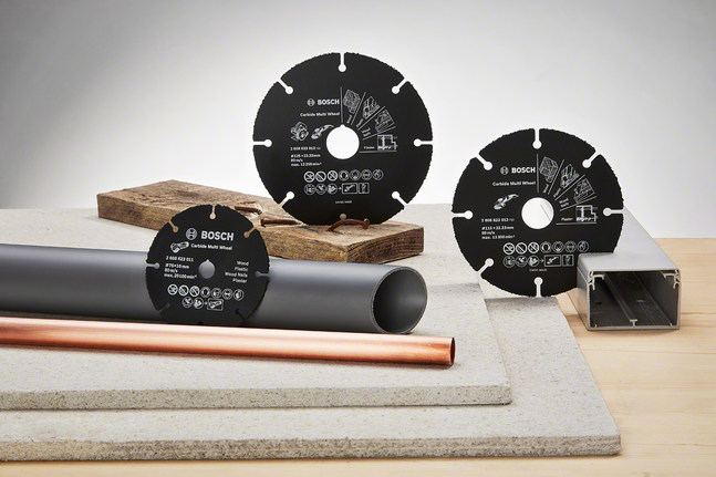 Three circular saw blades displayed with wood, pipes, metal, and construction materials.