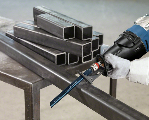 Person wearing safety equipment cuts a metal beam with a reciprocating saw.