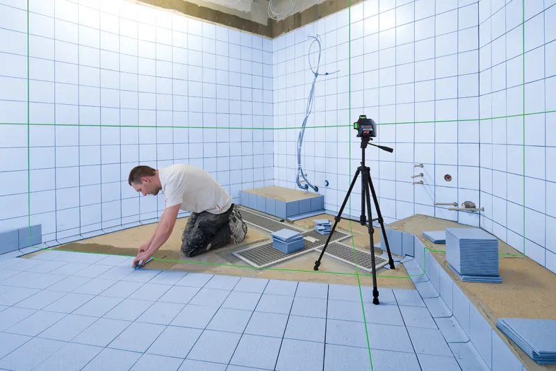 Man installing bathroom tiles.