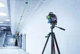 Laser level aligning ceiling.