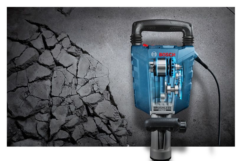 Jackhammer breaking concrete surface.
