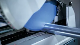 Kružna pila reže metalnu cijev u radionici.