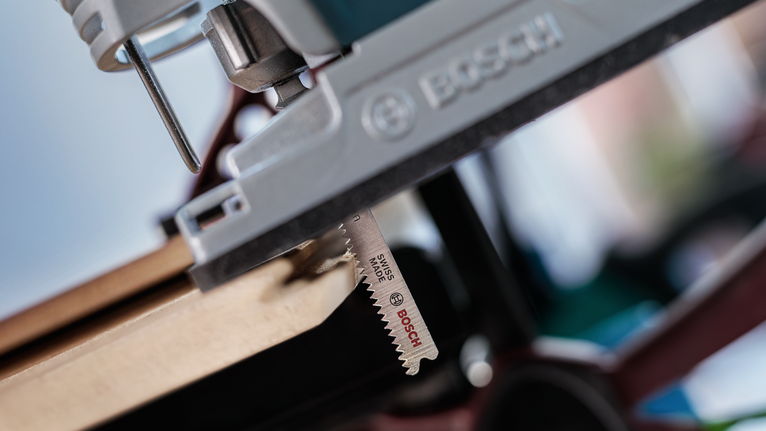 פאזל חותך דרך לוח עץ בסדנה.