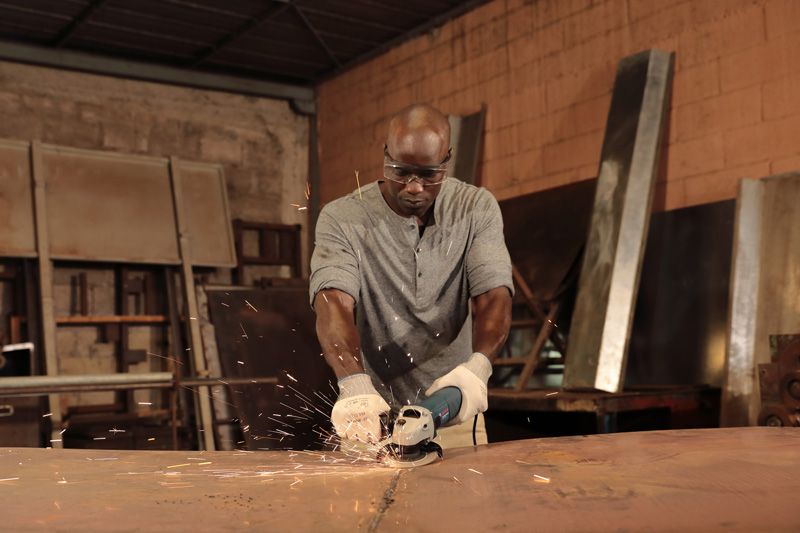 Man grinding metal sparks.