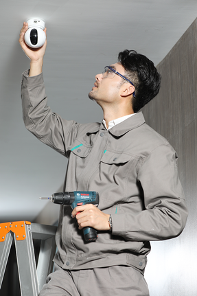 Installing security camera, drilling.