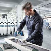 Bosch ISR 18V-30 PHX screwdriver in use, auto shutoff torque.