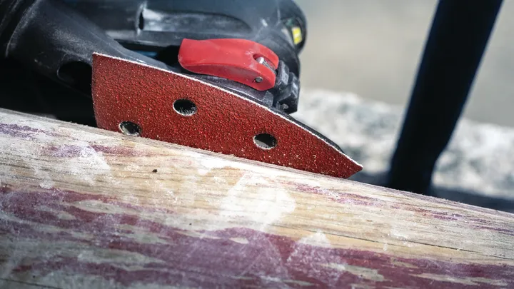 Detail sander smoothing a wooden surface.