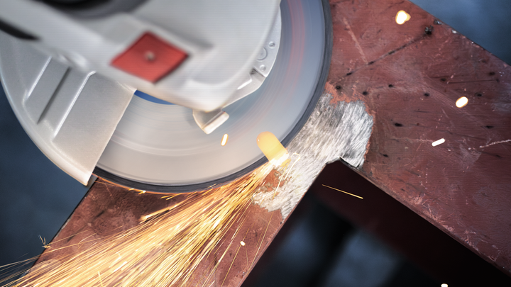 Angle grinder cutting through metal with bright sparks flying.
