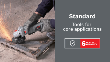 A Bosch tool cuts metal, sparks flying, on a concrete surface with a warranty label.