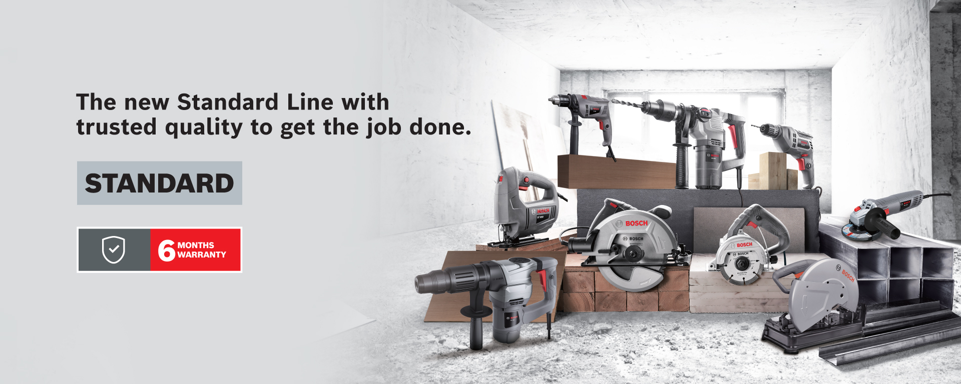 Bosch tools arranged on wooden blocks in a bright, unfinished space.