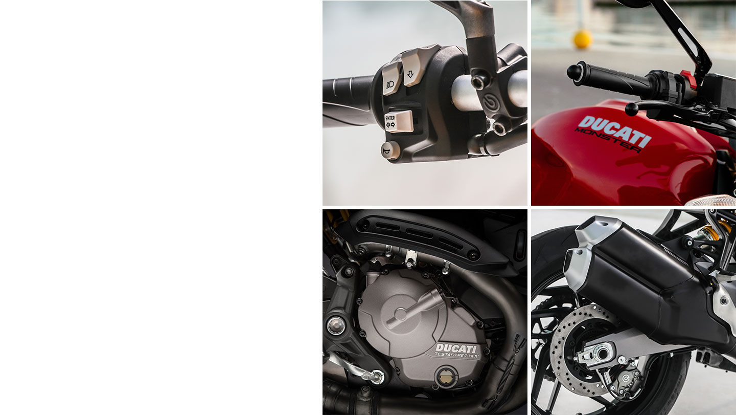 Dettagli di moto Ducati: manubrio, motore e scarico in primo piano.