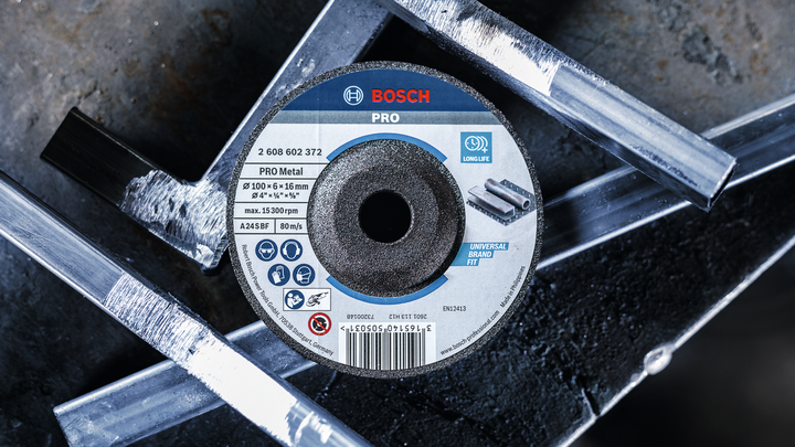 Metal grinding disc placed among cut metal bars.