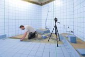 Man installing bathroom tiles.