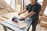 Table saw cutting wood.