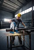 A person wearing safety equipment cuts steel pipes, creating sparks with a power saw.