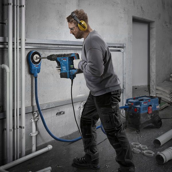 Bosch GBH6-42VB rotary hammer drilling wall.