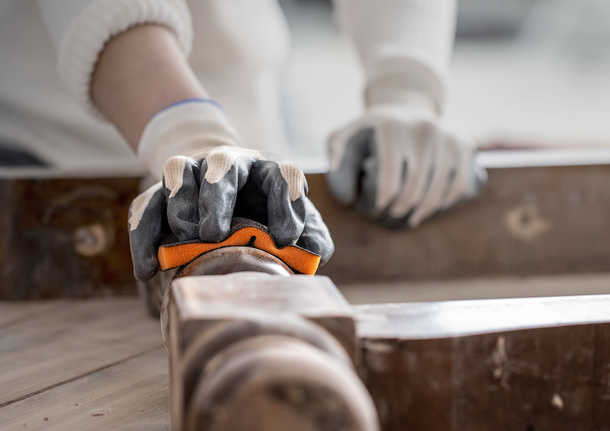 Bosch sanding block smoothing wooden furniture.