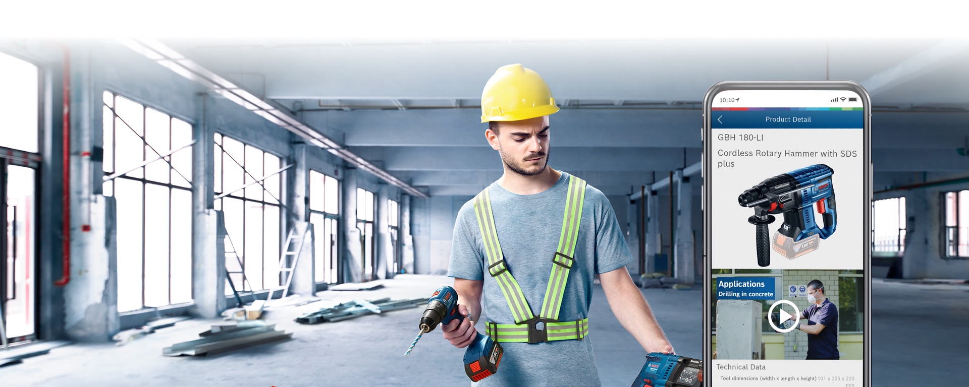 Man with yellow helmet and Bosch drill in empty space.